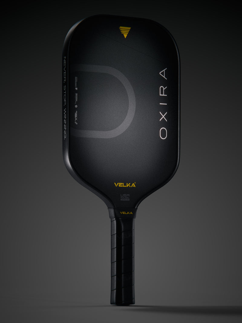 Velka's Oxira pickleball paddle in a dark background.